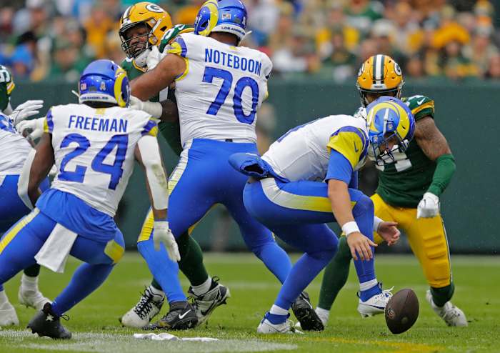 Los Angeles Rams quarterback Brett Rypien (11) tries to recover his fumble against the Green Bay Packers during their football game Sunday, November 5, 2023, at Lambeau Field in Green Bay, Wis.